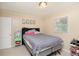 Neutral bedroom with headboard, window, and green side table at 3338 Orchard Ave, Indianapolis, IN 46218