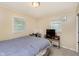 Neutral bedroom with TV, desk, and double windows at 3338 Orchard Ave, Indianapolis, IN 46218