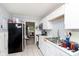Galley kitchen featuring white cabinets, stainless steel appliances, and tile flooring at 3338 Orchard Ave, Indianapolis, IN 46218