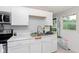 Functional kitchen featuring white cabinets, marble countertops, and stainless steel appliances at 3338 Orchard Ave, Indianapolis, IN 46218