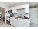 Galley kitchen featuring white cabinets, stainless steel appliances, and tile flooring at 3338 Orchard Ave, Indianapolis, IN 46218