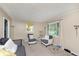 Comfortable living room with neutral tones, ample seating, and natural lighting from a window at 3338 Orchard Ave, Indianapolis, IN 46218