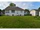 Spacious backyard with detached garage, lush green lawn, and tidy landscaping at 341 Barton Ave, Indianapolis, IN 46241