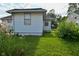 Well-maintained lawn and white siding of this charming home makes for a peaceful outdoor space at 341 Barton Ave, Indianapolis, IN 46241