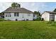 Spacious backyard with detached garage, lush green lawn, and tidy landscaping at 341 Barton Ave, Indianapolis, IN 46241