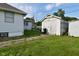 Yard featuring a detached garage, lush green lawn, and tidy landscaping at 341 Barton Ave, Indianapolis, IN 46241