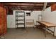 Unfinished basement with shelving and work benches at 341 Barton Ave, Indianapolis, IN 46241