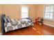 Sunlit bedroom with hardwood floors and a comfortable bed at 341 Barton Ave, Indianapolis, IN 46241