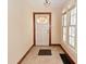 Cozy foyer featuring tile floors, a white front door and a large window to the left at 341 Barton Ave, Indianapolis, IN 46241