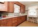 Charming kitchen featuring wood cabinetry, a cozy eating nook, and ample counter space at 341 Barton Ave, Indianapolis, IN 46241