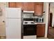 Functional kitchen featuring retro white appliances, wood cabinets, and classic design at 341 Barton Ave, Indianapolis, IN 46241