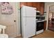 Classic kitchen features white refrigerator, retro range, and wooden cabinets at 341 Barton Ave, Indianapolis, IN 46241