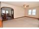 Spacious living room featuring a ceiling fan, neutral walls, and access to the dining area at 341 Barton Ave, Indianapolis, IN 46241