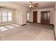 Spacious living room featuring neutral walls and carpet, a ceiling fan, and multiple windows at 341 Barton Ave, Indianapolis, IN 46241