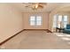 Bright living room featuring natural light from the multiple windows, ceiling fan and neutral carpet at 341 Barton Ave, Indianapolis, IN 46241