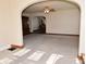 Bright living room with neutral carpet, dark wood trim, arched doorways, and ceiling fan at 341 Barton Ave, Indianapolis, IN 46241