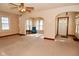Bright living room featuring natural light from the multiple windows, ceiling fan and neutral carpet at 341 Barton Ave, Indianapolis, IN 46241