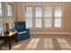 Sunlit living room featuring neutral walls and carpet, a ceiling fan, and multiple windows at 341 Barton Ave, Indianapolis, IN 46241