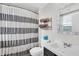 Bathroom with a striped shower curtain, mirror, and dark wood cabinets at 350 N Meridian St # 705, Indianapolis, IN 46204