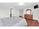 Comfortable bedroom with wood floors, natural light, and an elegant dresser at 350 N Meridian St # 705, Indianapolis, IN 46204