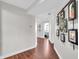 Hallway view leading to bedroom, featuring wood floors and modern framed pictures at 350 N Meridian St # 705, Indianapolis, IN 46204