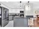 Modern kitchen with gray lower cabinets, white upper cabinets, granite counters, and stainless steel appliances at 350 N Meridian St # 705, Indianapolis, IN 46204