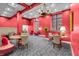 Charming lounge with red accents, ornate chandeliers, and large windows bringing in light at 350 N Meridian St # 705, Indianapolis, IN 46204