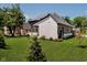 Landscaped backyard view of a modern two-story home with a gray roof at 3713 Cherwell Dr, Zionsville, IN 46077