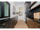 A convenient bar area with dark counters and wood cabinets offers extra storage and utility at 3713 Cherwell Dr, Zionsville, IN 46077
