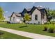 A modern home displays professional landscaping and a manicured lawn, and a sidewalk at 3713 Cherwell Dr, Zionsville, IN 46077