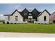 Well maintained lawn and garden beds accent a modern home's exterior with a sidewalk at 3713 Cherwell Dr, Zionsville, IN 46077
