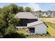 Modern home featuring a covered patio, professional landscaping, and a manicured lawn at 3713 Cherwell Dr, Zionsville, IN 46077