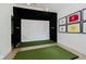 Entertainment room with golf simulator, framed athletic awards, and professional artificial turf at 3713 Cherwell Dr, Zionsville, IN 46077