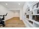 Hallway with a bike and built-in shelving for displaying trophies and memorabilia at 3713 Cherwell Dr, Zionsville, IN 46077