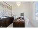 The home office is bright and airy with a stylish desk, modern art and sleek storage at 3713 Cherwell Dr, Zionsville, IN 46077