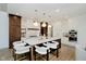 Spacious kitchen boasts an island with seating, pendant lighting, and modern white and wood cabinetry at 3713 Cherwell Dr, Zionsville, IN 46077