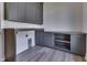 Laundry room with gray cabinets, countertops and hardware with wood look floors at 3713 Cherwell Dr, Zionsville, IN 46077