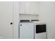 Bright laundry room featuring white cabinets, modern washer, and dryer units at 3713 Cherwell Dr, Zionsville, IN 46077