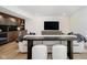 Cozy living room with a built-in bar, a large television and comfortable seating at 3713 Cherwell Dr, Zionsville, IN 46077
