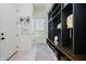 Mudroom featuring tile floors, a window, a built in bench with storage, and a storage system at 3713 Cherwell Dr, Zionsville, IN 46077