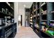 A large butler's pantry is shown with black shelving and a refrigerator perfect for storage at 3713 Cherwell Dr, Zionsville, IN 46077