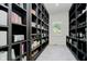 A walk-in pantry is well organized with ample shelving and storage with natural light from a window at 3713 Cherwell Dr, Zionsville, IN 46077