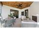 Covered patio with an outdoor fireplace, comfortable seating, and wood ceilings at 3713 Cherwell Dr, Zionsville, IN 46077