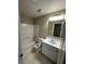 Well-lit bathroom featuring a shower-tub combo, sleek mirror, and a tiled floor at 3861 Candle Berry Dr, Indianapolis, IN 46235