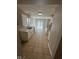 Well-lit kitchen featuring modern white cabinetry, tile flooring, and sliding glass doors at 3861 Candle Berry Dr, Indianapolis, IN 46235