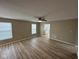 Bright living room with a ceiling fan, fresh paint, laminate flooring, and lots of natural light at 3861 Candle Berry Dr, Indianapolis, IN 46235