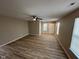 Cozy living room with new flooring, fresh paint, windows for natural light, and an elegant ceiling fan at 3861 Candle Berry Dr, Indianapolis, IN 46235
