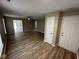 Spacious living room featuring modern wood flooring and open access to other areas of the home at 3861 Candle Berry Dr, Indianapolis, IN 46235