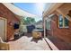 Cozy brick backyard featuring a hot tub, outdoor seating, and lush landscaping at 3975 Offshore Dr, Columbus, IN 47203