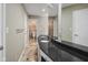 Well-lit bathroom featuring double sinks, a dark granite countertop, and an adjacent tiled shower at 3975 Offshore Dr, Columbus, IN 47203
